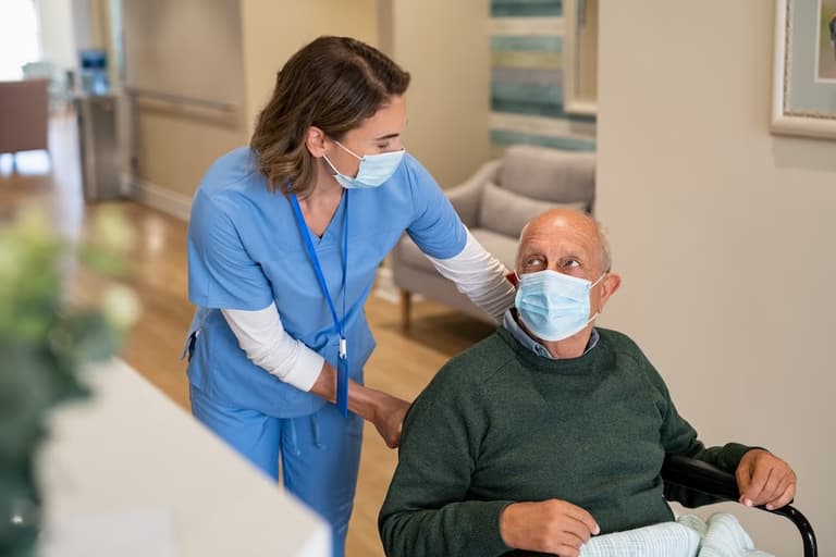 Nurse helping man with complex care needs