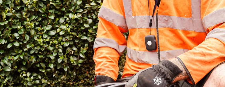 Lone worker device around the neck of road traffic worker