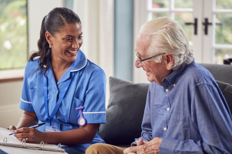 Caregiver talking to a senior man